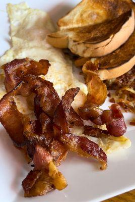 3 eggs over easy, bacon, hash browns and buttered white toast!