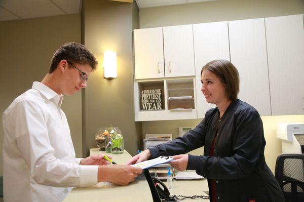 Reception staff at Renton Smile Dentistry welcomes a patient