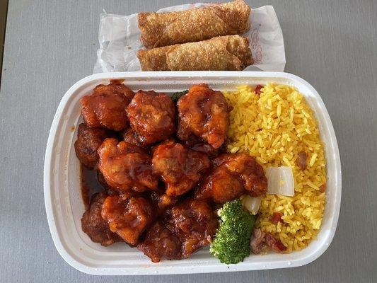 General Tso chicken with fried rice and egg rolls.