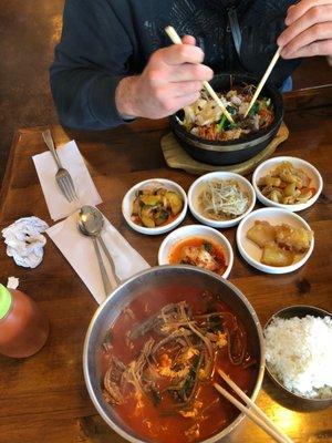 Yukgaejang and Dolsot Bibimbap and a variety of banchan.