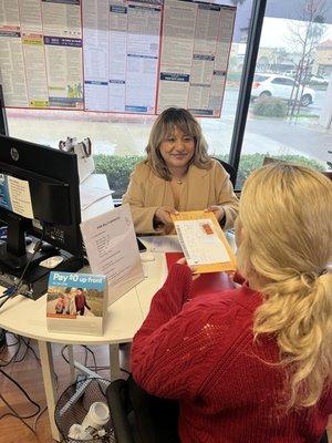 A satisfied customer receiving her license plate and updated sticker ! Come on by to KMA for fast and easy auto registration service !