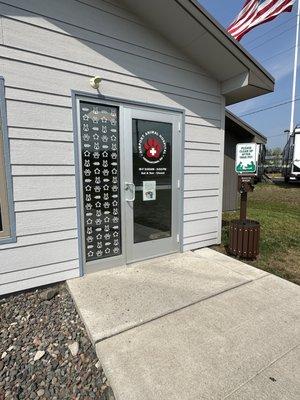 Entrance, hours, and poop bag station