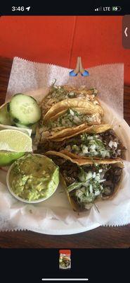 mix of chicken and steak tacos with a side of guac