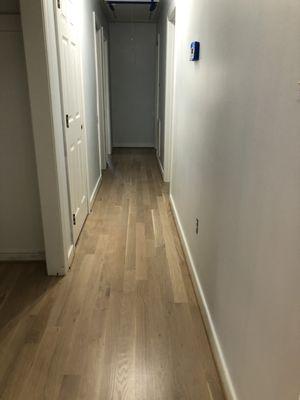 Hallway, kitchen, and living room. White oak with a subtle white finish.