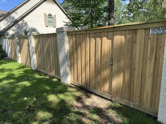 8' Cedar Privacy Fence with Trim & a seamlessly integrated gate in between existing brick columns