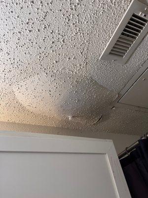 popcorn ceiling paint falling off as a result of water dripping from the ceiling