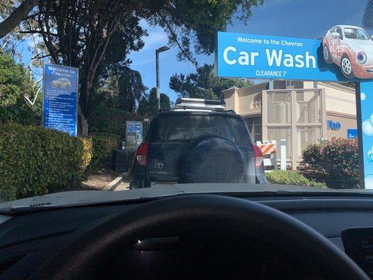 Waiting in line for drive thru wash