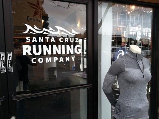 The new Santa Cruz Running Company store logo goes up on our doors. Come on in and get your running shoes!