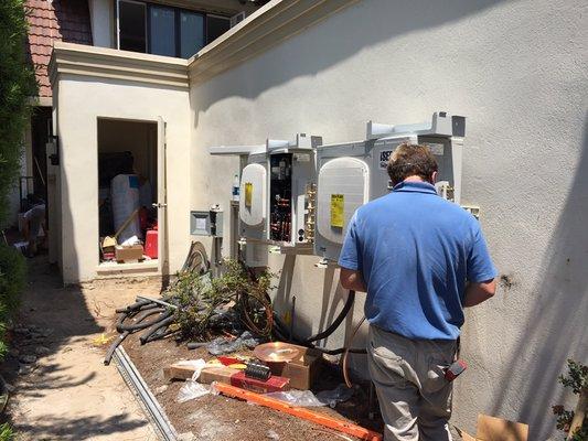 22 SEER variable refrigerant flow space saving systems being installed remotely to open up courtyard space.