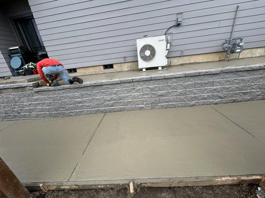 Retaining wall with concrete above and below