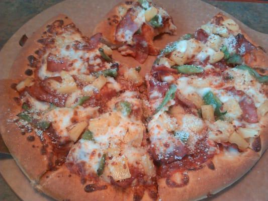 Ham, pineapple, and green pepper pan pizza with parmesan cheese