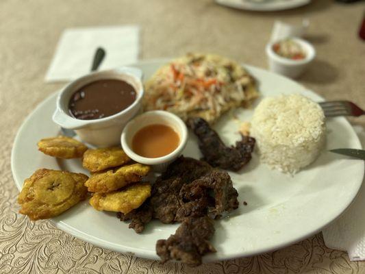 Plato Guanaca: rice, red beans, steak, pupusa, and some of the best tostones I've ever eaten