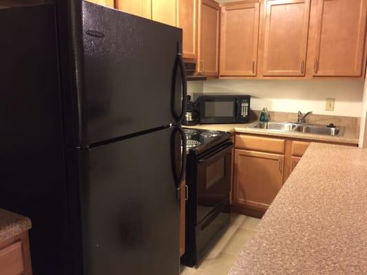 Kitchen with full-size fridge.