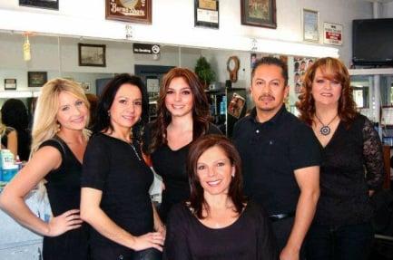 Delia surrounded by her barber staff at DELIA'S BARBER SHOP in Old Town La Verne