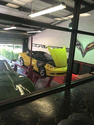 My Yellow C6 Corvette on the lift at Eismann's Corvette Center