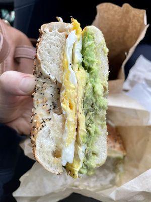 Breakfast sammie on a soft everything bagel with two eggs, cheddar, and avocado