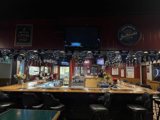 Beautiful Bar with Lights and Flags. Flowers on the bar too!