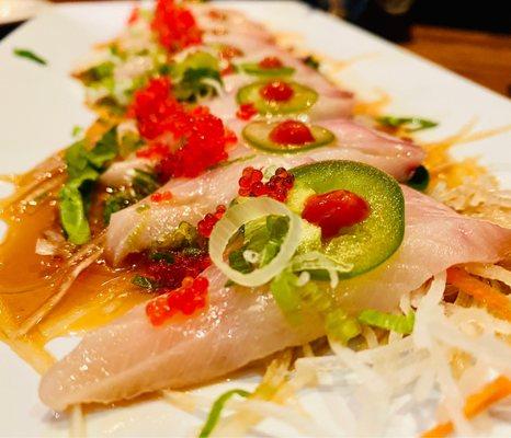 Super fresh yellowtail with aromatic fresh basil & jalapeño appetizer on a bed of fine radish YUM YUM YUM :)...