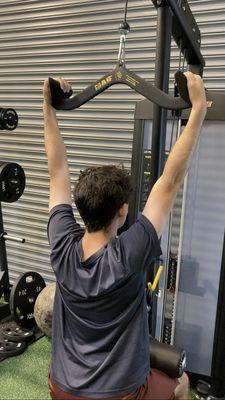 Hunter executing Lat Pulldowns with full range of motion and eccentric control.