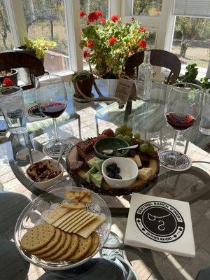 Charcuterie Board and wine flight in the beautiful wind-protected sun room!