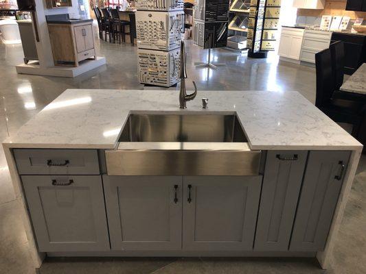 A beautiful kitchen island with Carrera marble top and stainless apron front. One of many kitchen options available through Back Home