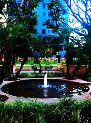 Miniature fountain directly in front of the building