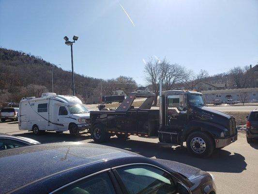 16 ton wrecker towing a small rv