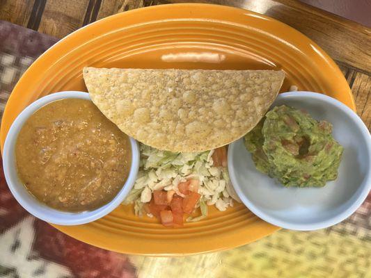 Ground beef taco with special hot sauce and Guacamole.