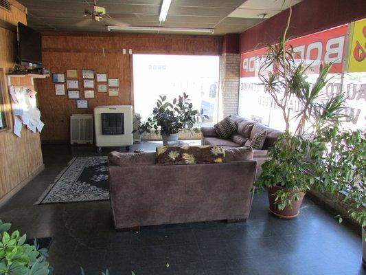 Showroom with a place for customers to sit and wait on their vehicles.