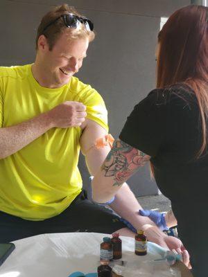 Happy customer receiving a Vitamin Injection at our Event at Pinon in Midtown.