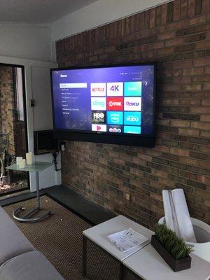 4 Seasons Room Outdoor Sunbrite TV mounted to Brick Wall