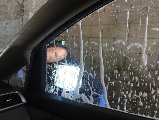 Hand wiping the windows, tires and doors.