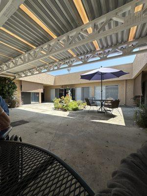 Courtyard table seating with (empty?) vending machines.