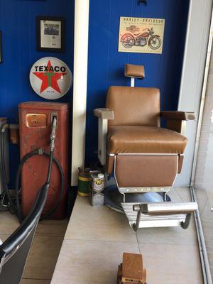 Old school barber chair and Texaco pump.  This barber shop has character.