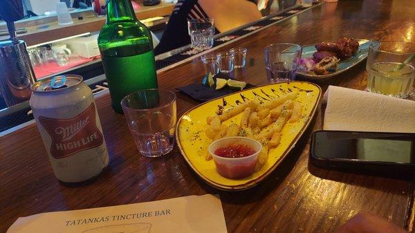 Spread of wings, fries and tequila shots