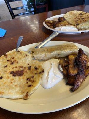 Salvadoran Combo plate with pupusa, tamale, plantains and sour cream.