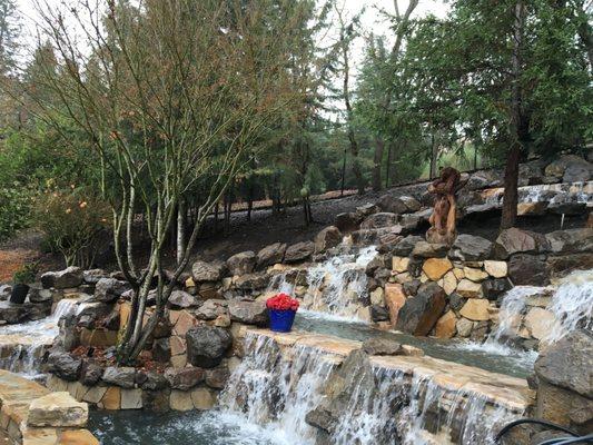 Beautiful manmade waterfall of boulders and flagstone.