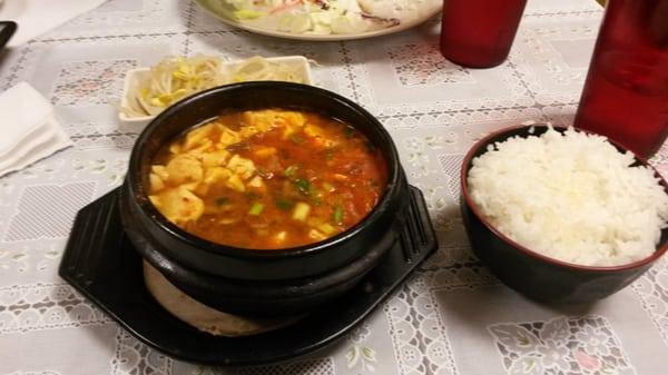 Spicy tofu soup, you take a spoonful of rice with the soup and enjoy the korean style bean sprouts on the side