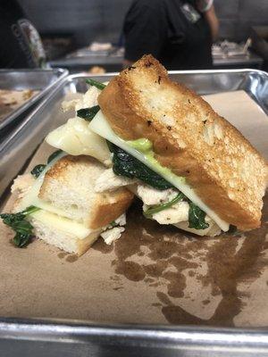 The Spartan with lemon oregano chicken, spinach, garlic herb spread, havarti, cheddar, and feta