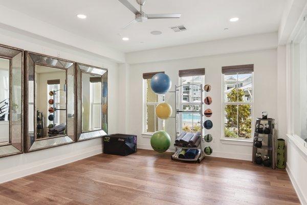 Spacious gym area with yoga balls, kettlebells, yoga mats, and foam roller at Lantower Edgewater