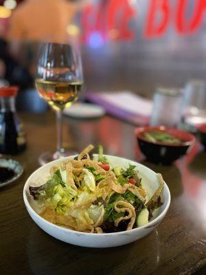 House salad with ginger carrot dressing and a glass of house Chardonnay