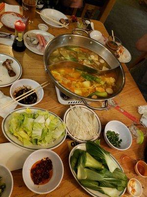 Seafood hotpot  with two different broths choices of baby Bok choy, enoki mushrooms,  and  Napa cabbage