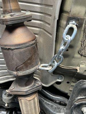 heavy duty chain welded to catalytic converter and frame