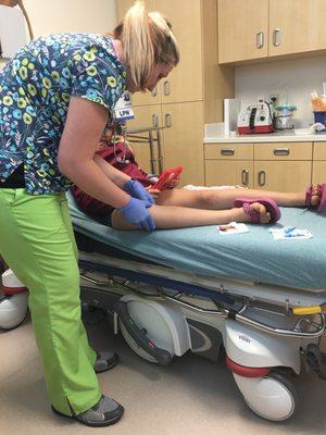 Brittany, the awesome LPN who worked with our daughter, applying numbing gel pre-stitches