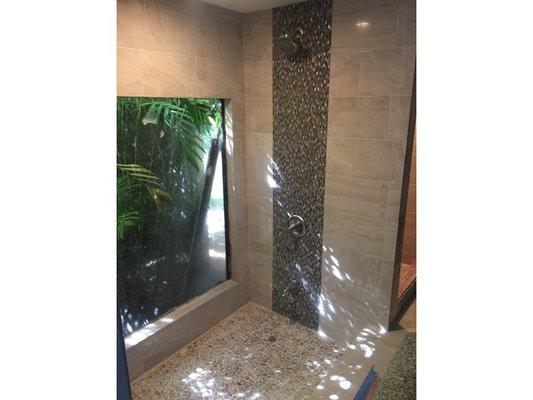 What was once an unused Roman Tub is now an enchanting tropical shower.