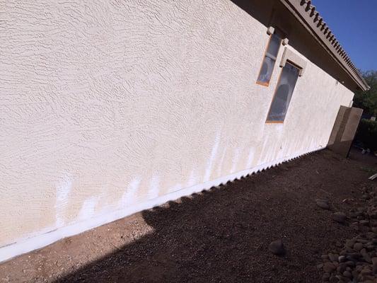 Sealing the foundation with a water proofing primer, one of the many steps of prep we do