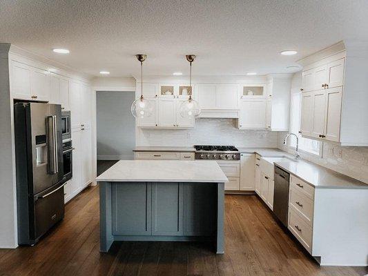 Remodeled kitchen: new cabinetry, countertops, tile backsplash, engineered hardwood floors, paint