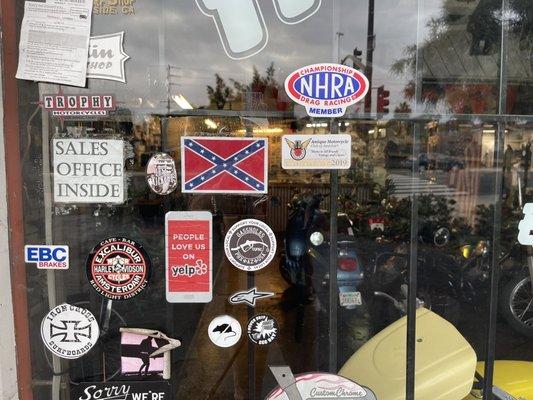 Confederate flag right next to the yelp sticker on the window of Moreland Choppers.