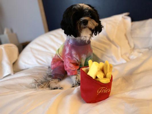 Our sweet girl in her tie dye  onesie and her French fry toys.