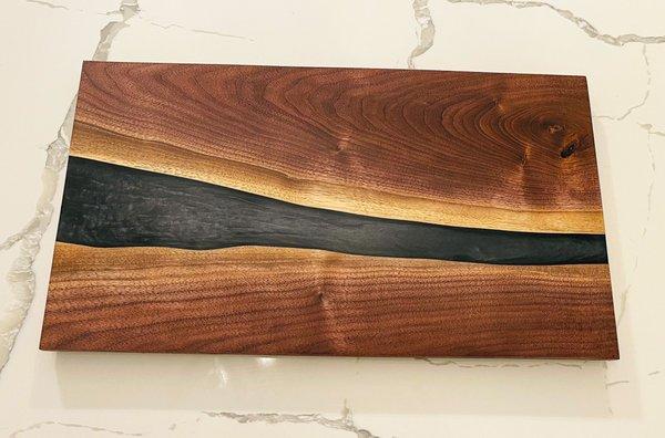 Black walnut serving board with black resin.